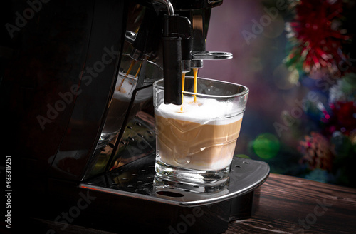 Preparing a fresh cappuccino with a home coffee machine. Coffee preparation. photo