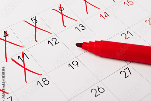 close up of a calendar page with red pen