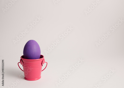 Photography Minimal purple Easter egg in the pastel pink cannikin