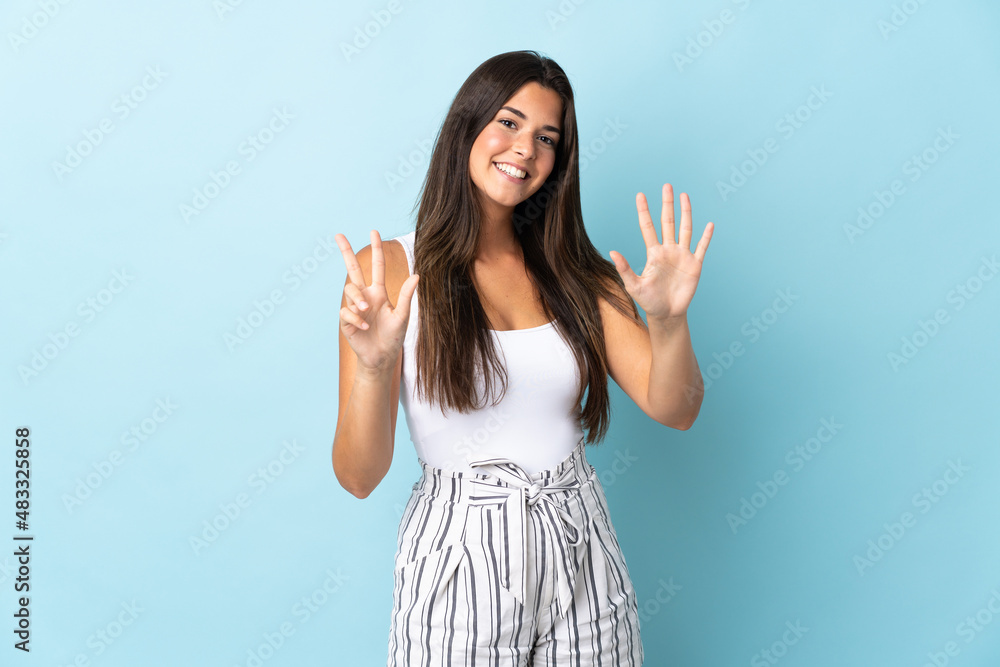 Young brazilian woman isolated on blue background counting eight with fingers Young brazilian woman isolated on blue background counting eight with fingers