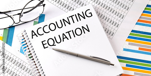 ACCOUNTING EQUATION , pen and glasses on the chart, business concept