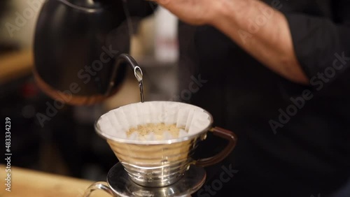 unrecognizable barista making american coffee with a filter and a hot water jug