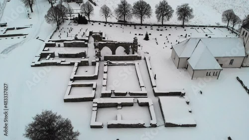 Aerial Flyover Of Stone Ruins Of A Historical Medieval Abbey In Europe photo