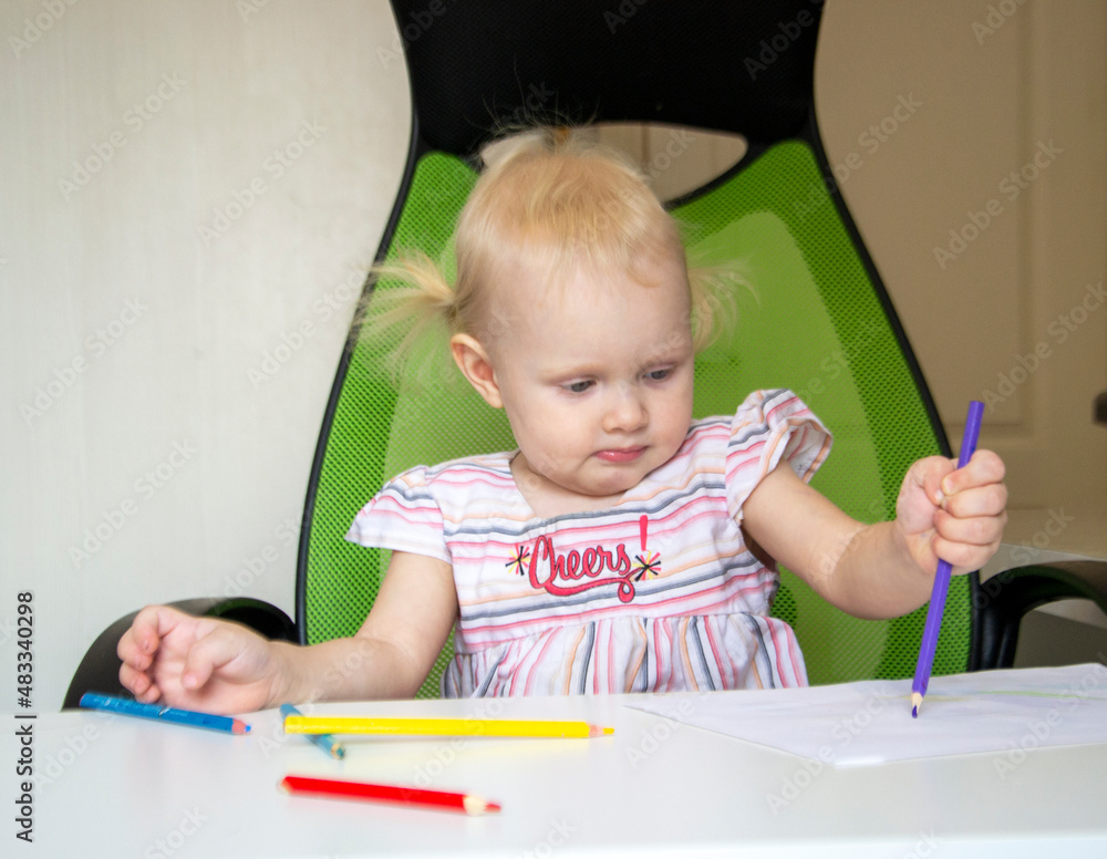 Little baby girl draws with colored pencils Little baby girl draws with colored pencils