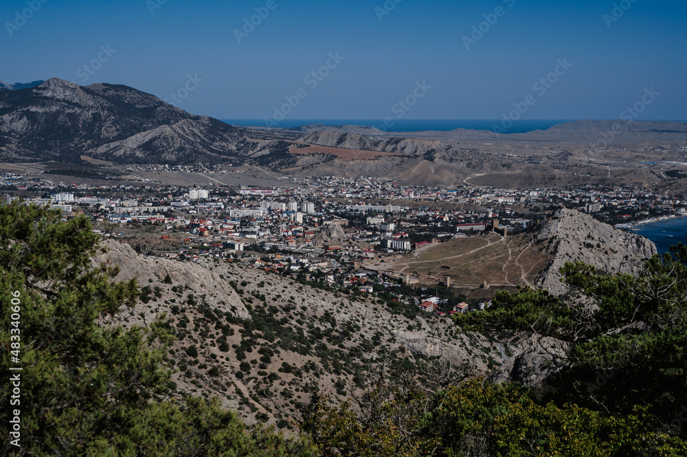 View of ancient city of Sudak and Genoese fortress on Black Sea coast in Crimea on sunny summer day