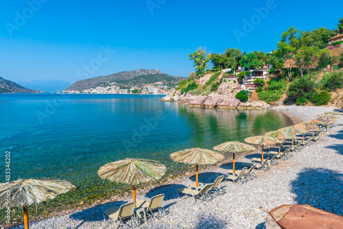 straw umbrellas on sandy sea beach on exotic resort