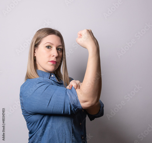FEMALE POWER , Woman with raised fist and rolled-up shirt