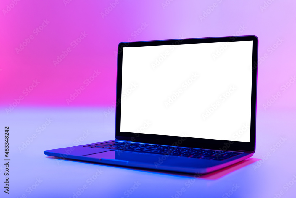 Modern laptop pc with empty white screen in neon light, space for website or desktop. Mockup Modern laptop pc with empty white screen in neon light, space for website or desktop. Mockup