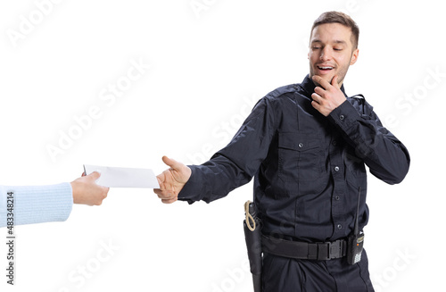 Portrait of young man, policeman wearing black uniform refuses a bribe isolated on white background. Concept of job, caree, law and order. photo