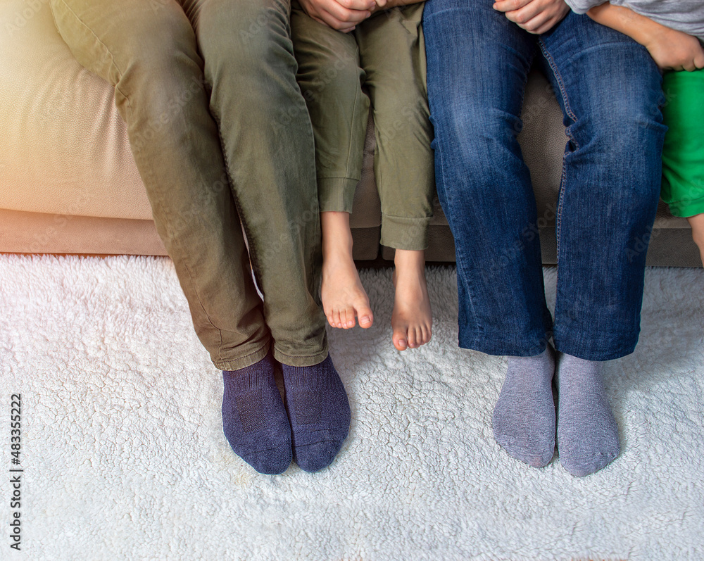 Cropped shot of a family of three relaxing together on the sofa at home Cropped shot of a family of three relaxing together on the sofa at home
