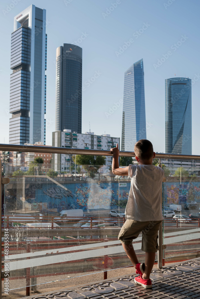 Child looking at Financial District at Cuatro Torres in Madrid Child looking at Financial District at Cuatro Torres in Madrid