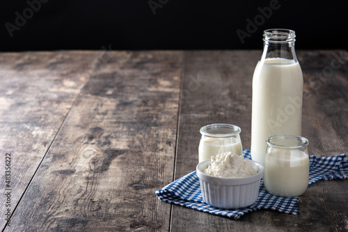 Milk kefir drink on wooden table. Liquid and fermented milk product on wooden table. Copy space