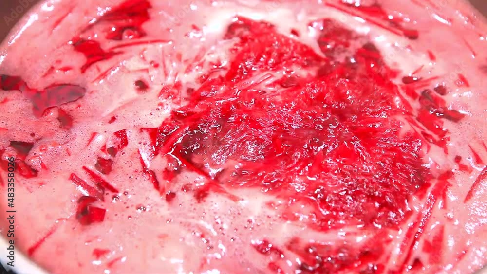 Cooking at home. Boiling red soup, close-up, until frothy. Chopped beetroot in a saucepan. Cooking at home. Boiling red soup, close-up, until frothy. Chopped beetroot in a saucepan.