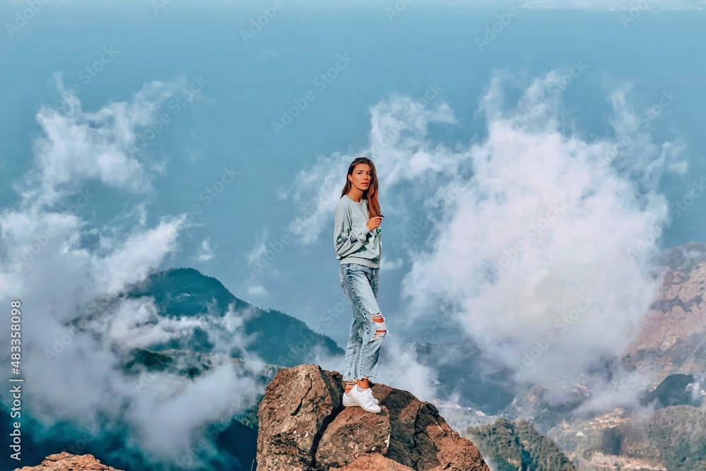 woman over the mountains from madeira pico do arieiro portugal 
