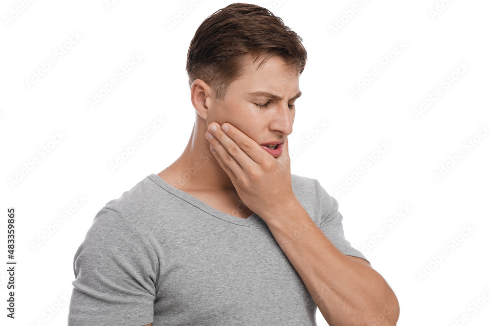 Frustrated sad young european male suffering from toothache, feeling unwell Frustrated sad young european male suffering from toothache, feeling unwell