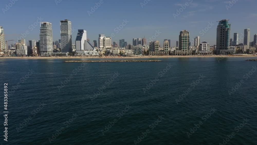 Revealing drone shot flying low over water, rising towards modern skyline and beaches of Tel Aviv, Israel's dynamic creative and economic hub
Revealing drone shot flying low over water, rising towards modern skyline and beaches of Tel Aviv, Israel's dynamic creative and economic hub
