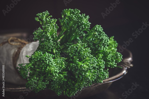 Fresh bimi vegetable on a dark table. Raw baby broccoli photo