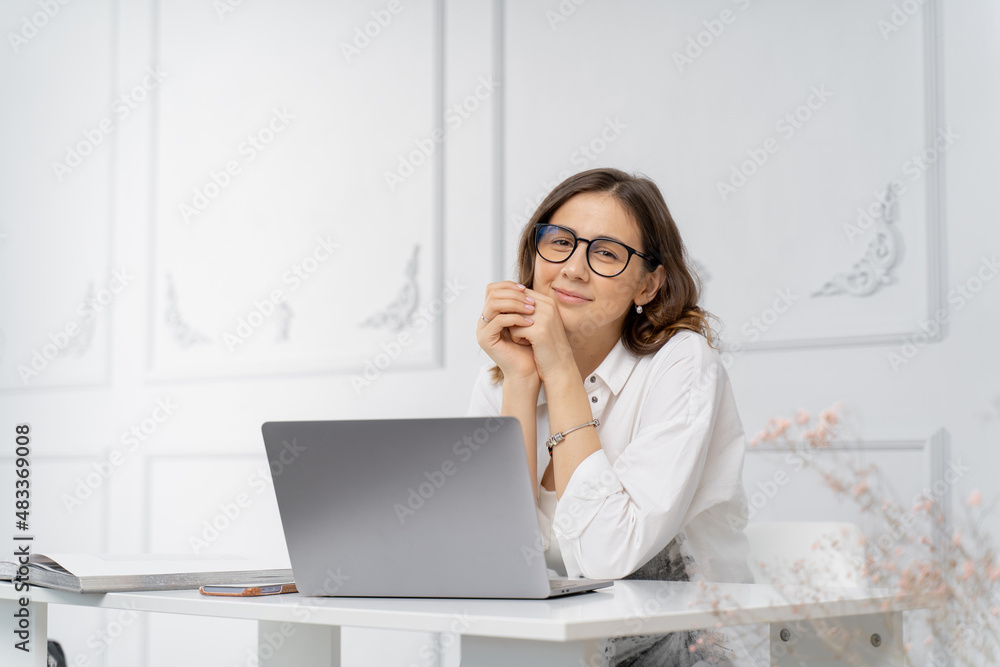 The girl at work looks at the camera The girl at work looks at the camera