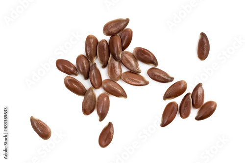 Close up of linseed or flax seed spread out and isolated on white background with light shadows