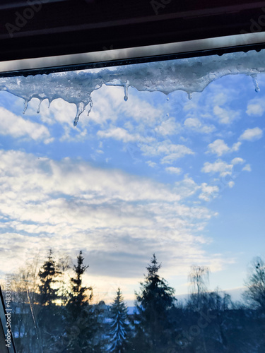 Taking photo of ice in a beautiful day full of snow. Looking out of the window during the winter.