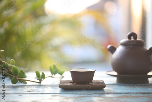 Earthenware brown teapot and tea cup