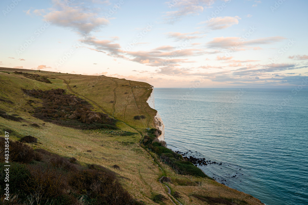 Beautiful landscape of white cliffs with seascape against dramatic cloudy sky, White cliffs of dover along sea