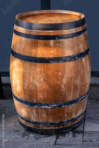 Wooden barrel on street pavement