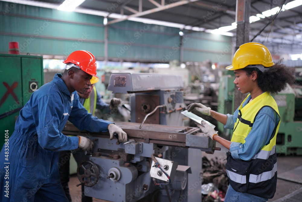 Industrial Engineers in Hard Hats.Work at the Heavy Industry Manufacturing Factory.industrial worker indoors in factory. man working in an industrial factory. Industrial Engineers in Hard Hats.Work at the Heavy Industry Manufacturing Factory.industrial worker indoors in factory. man working in an industrial factory.