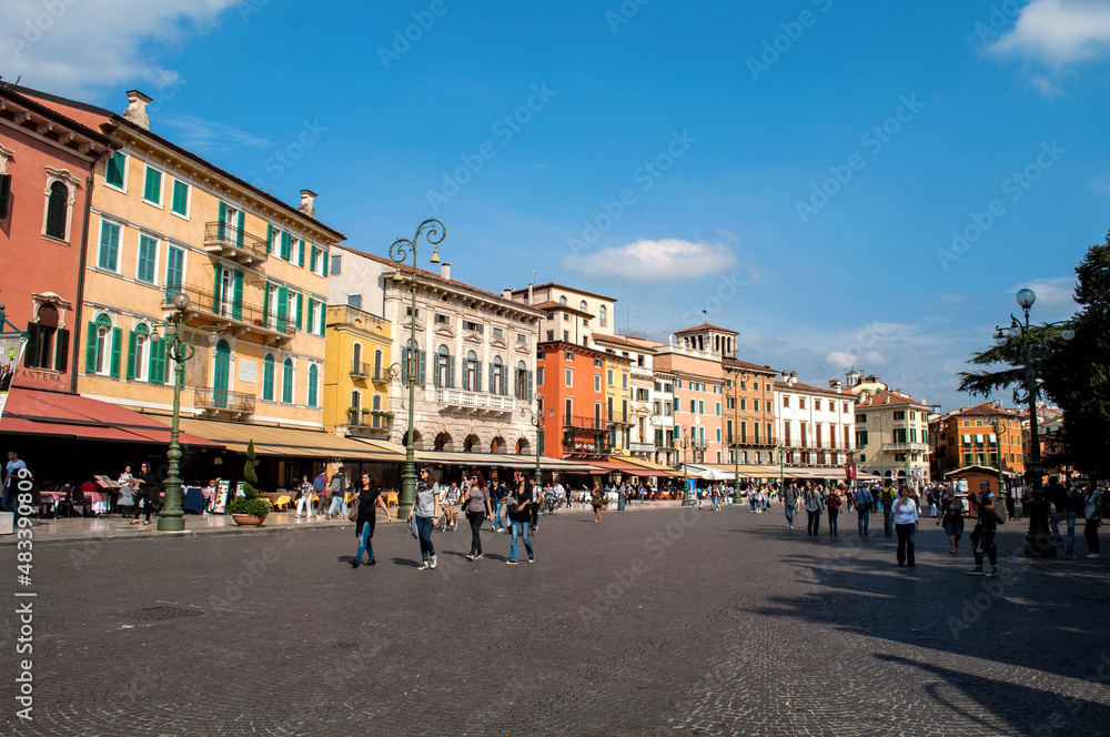 The main square in Verona, colorful houses, streets and people. Italy in summer.