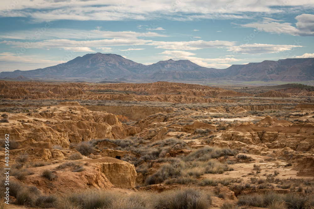 Uneven area of bad land with dry grass in desert valley Uneven area of bad land with dry grass in desert valley