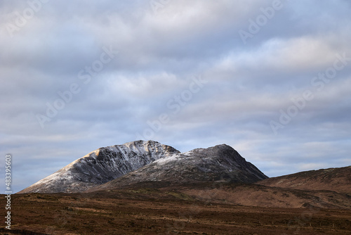 Errigal mountain. County Donegal. snowy peak in winter with cloudy sky and beautiful colors