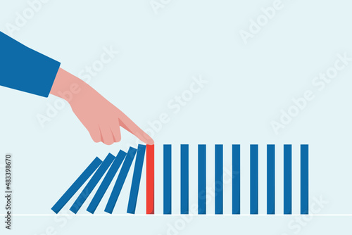 close-up hand The hand of a businessman who is stopping or preventing a falling block.Risk protection concept,Eliminating the risk