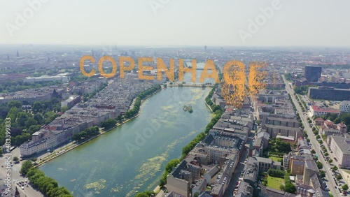 Inscription on video. Copenhagen, Denmark. Central historical part of the city, city roofs and Copenhagen lakes. Aerial view. Appears from the sand, Aerial View, Departure of the camera photo