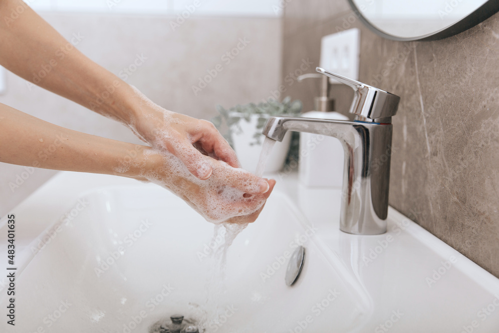 Washing hands under the flowing water tap. Washing hands rubbing with soap for corona virus prevention, hygiene to stop spreading corona virus in or public wash room. Hygiene concept hand detail Washing hands under the flowing water tap. Washing hands rubbing with soap for corona virus prevention, hygiene to stop spreading corona virus in or public wash room. Hygiene concept hand detail