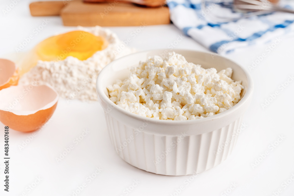 A collection of tools and ingredients for homemade baking with cottage cheese in the foreground. Cooking at home, an appetizing composition of products for cooking
