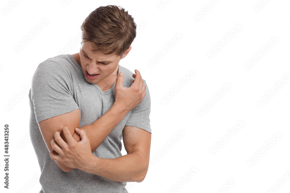 Upset young european male suffering from elbow pain with painful facial expression Upset young european male suffering from elbow pain with painful facial expression