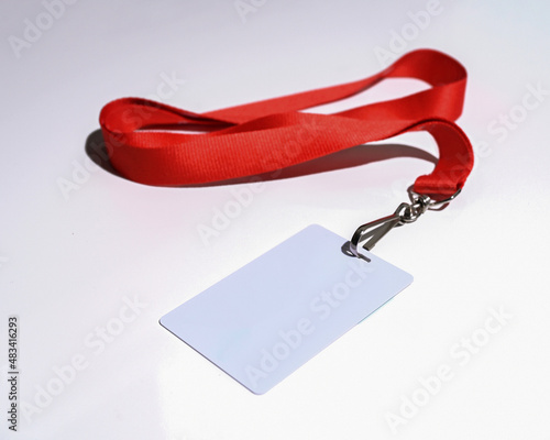 Red lanyard with blank badge isolated on white background closeup photo