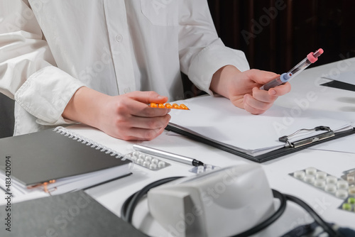 Medicine, doctor sitting at the table and writing a prescription to the patient, remote visit, online treatment, top view, medical background