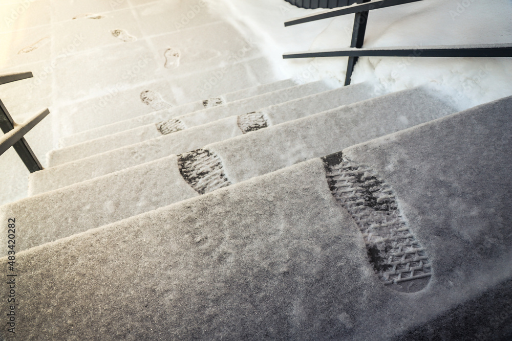 Footprints in the snow on the stairs. Outdoors. Winter