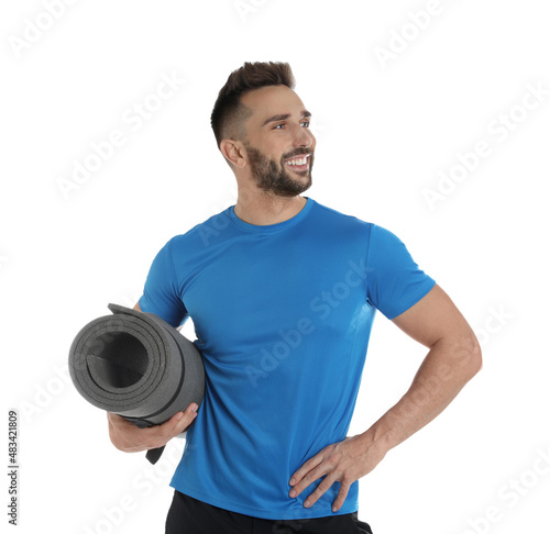 Handsome man with yoga mat on white background