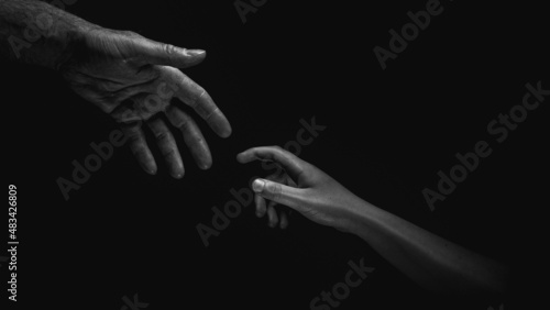 Adult Hand Reaching For Child Hand Offering Help
