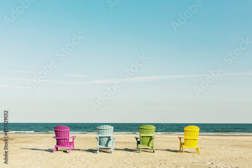 Billede på lærred Colorful lounge Adirondack chairs at Atlantic ocean beach