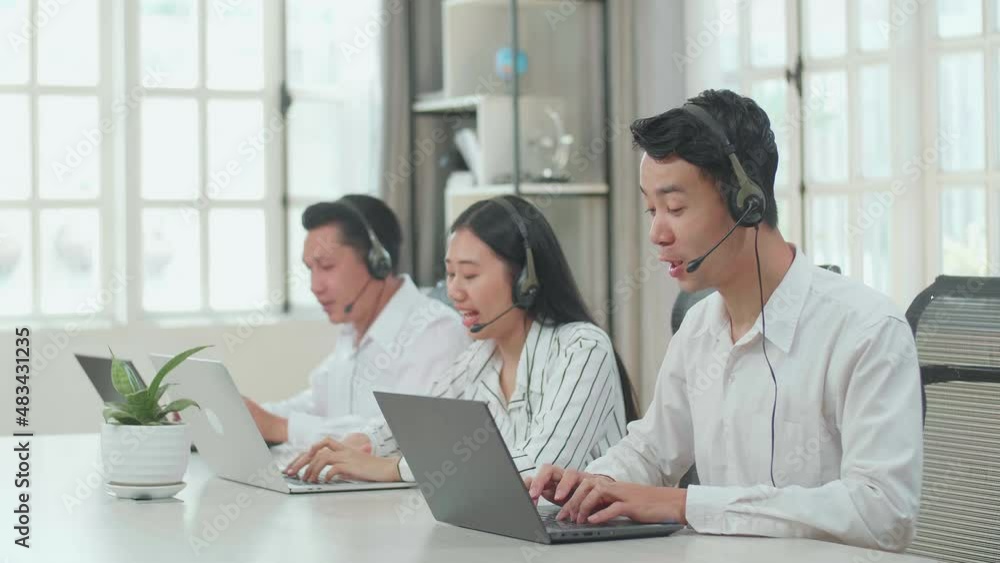 Three Asian Call Center Agents Wearing Headsets And Sitting On The Chairs And Typing On Computers While Speaking To Customers On The Call At The Office
Three Asian Call Center Agents Wearing Headsets And Sitting On The Chairs And Typing On Computers While Speaking To Customers On The Call At The Office