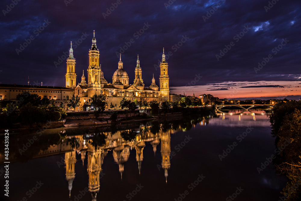 Cathedral-Basilica of Our Lady of the Pillar with evening lights,  Roman Catholic church in the city of Zaragoza, Aragon 