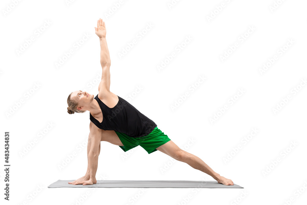 Extended lateral angle pose. Caucasian handsome man in green shorts practice Utthita parshvakonasana, isolated on white.