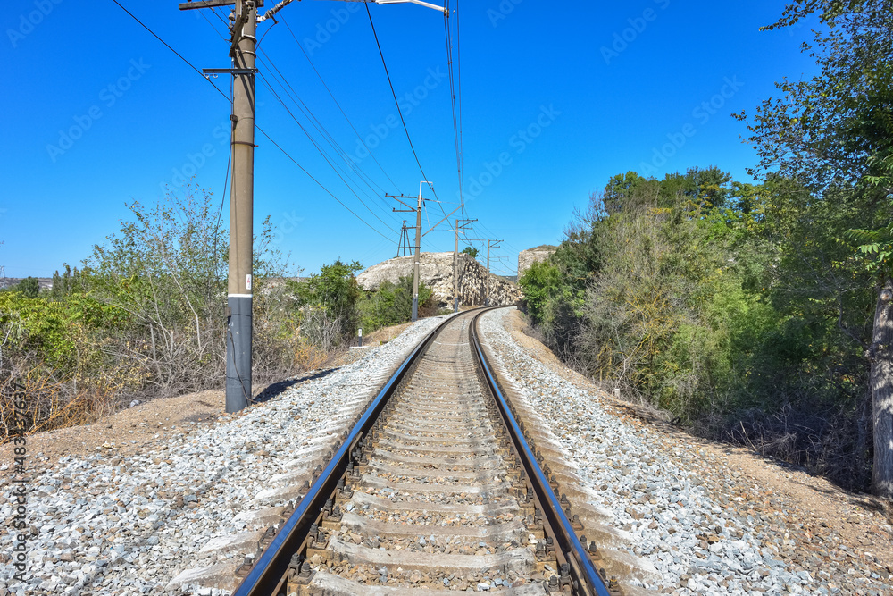 Empty railway with pillars, railway in mountains