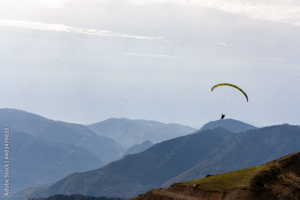 A man with a paraglider on a background of mountains A man with a paraglider on a background of mountains