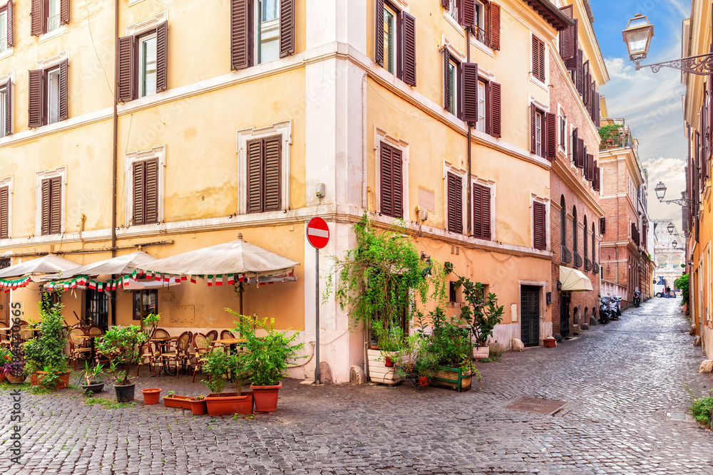 Traditional cozy Italian street with a cafe near Coliseum, Rome, no people