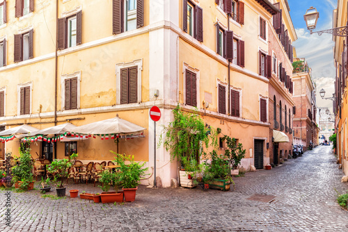 Traditional cozy Italian street with a cafe near Coliseum, Rome, no people photo