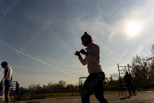 Silhouette of a girl exercising outside